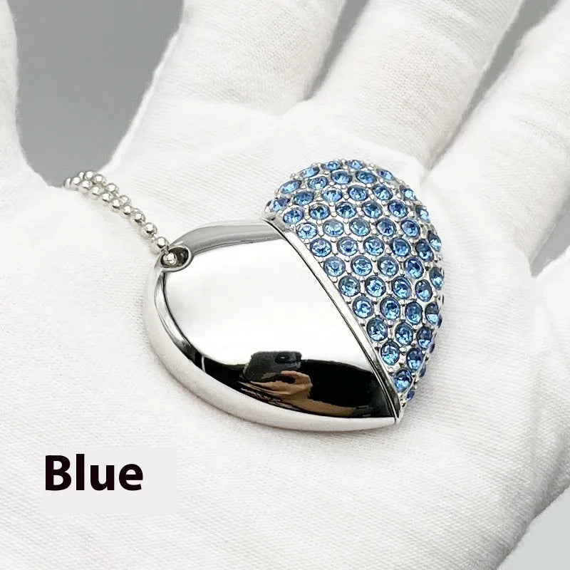 Brick-inlaid heart-shaped metal USB flash drive in multiple colours on a white background.