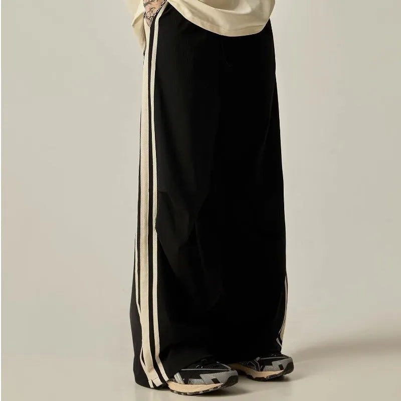 Black men's high waist wide leg climbing trousers on a hanger.