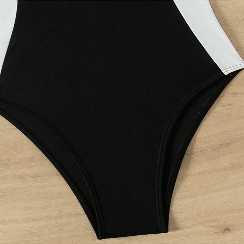 Black and white women's one-piece swimsuit with pearl spaghetti straps, sleeveless slim-fit design.