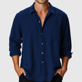 Man wearing a loose-fit, long sleeve casual shirt with a stand collar, ideal for beach holidays.