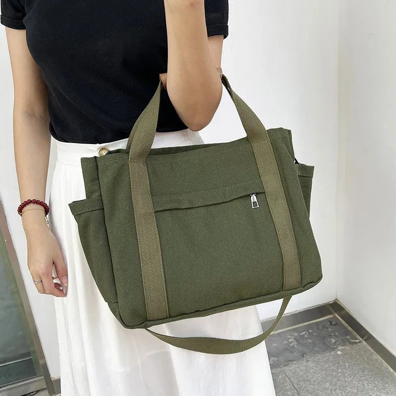 Large canvas tote bag with multiple internal compartments in horizontal square design