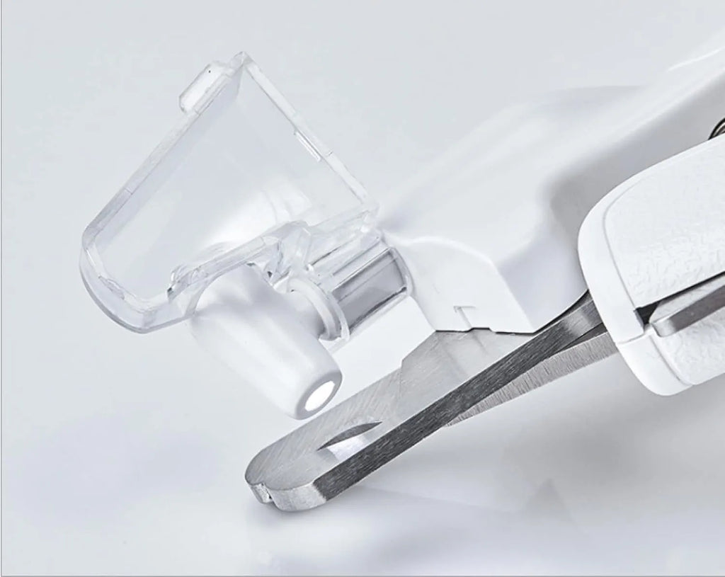 White pet nail clippers with LED light, transparent guard, triangular blades, and anti-slip handles for cat and dog grooming