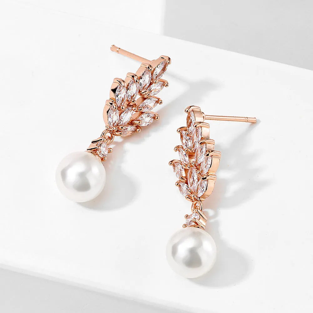 A pair of geometric stud earrings with a flower design and micro inlaid zircon, shown in gold plating.