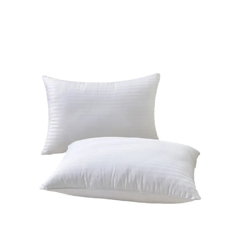 White hotel pillow with a satin stripe on a bed, showing low, medium, and high loft options.
