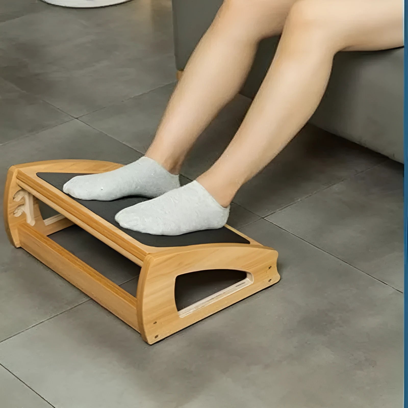 Wooden adjustable bamboo footstool in natural wood colour for office desk use.