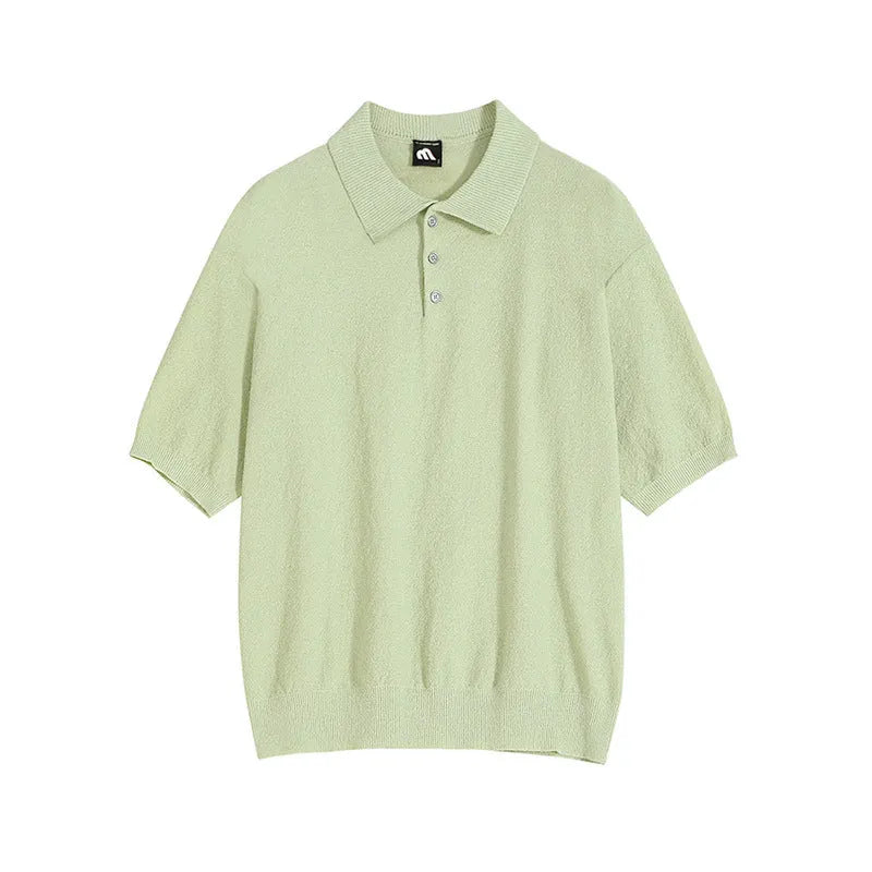 Man wearing a caramel coloured loose fit knitted polo shirt with short sleeves and an asymmetric design.