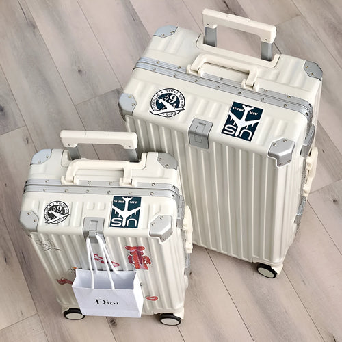Hard-shell aluminium frame suitcase in avocado green colour with USB port and universal wheels.