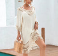 Apricot-coloured women's crocheted patchwork beach dress with half sleeves on a hanger.