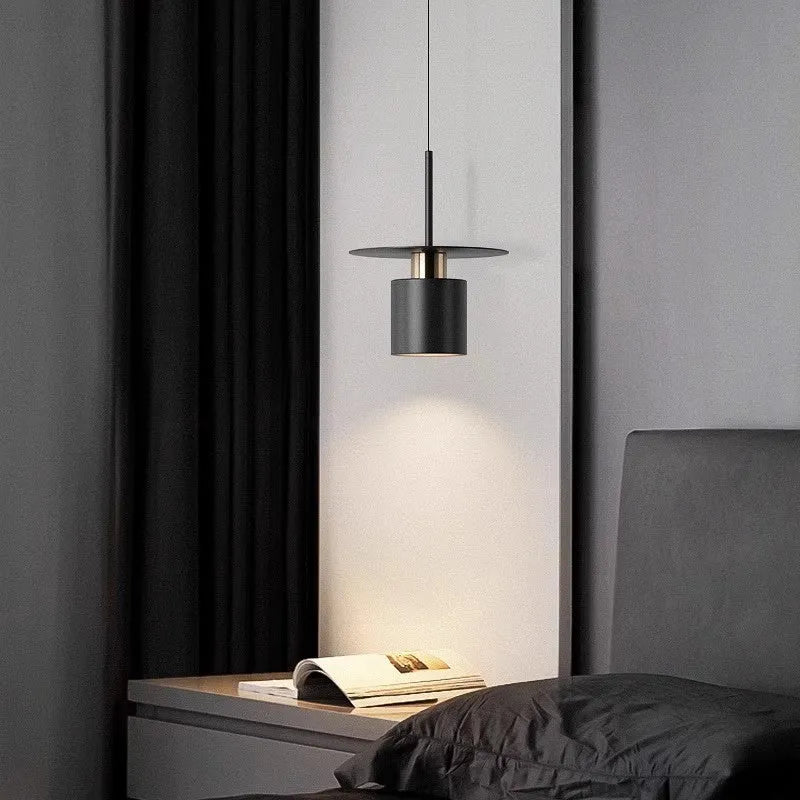 Modern minimalist black droplight pendant 20cm diameter on ceiling over a bedside table
