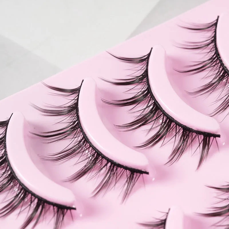 Pack of manga style false eyelashes showing natural wispy designs on plastic black terriers for cosplay and Korean makeup.