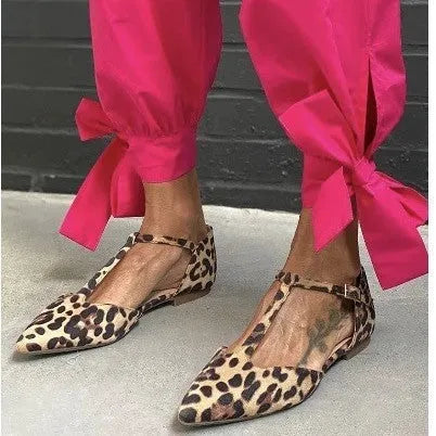 Leopard print women's pumps with pointed toe, chunky low heel, and ankle strap