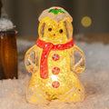 Glowing plastic gingerbread man Christmas ornament with red scarf, showing modern design and compact size.