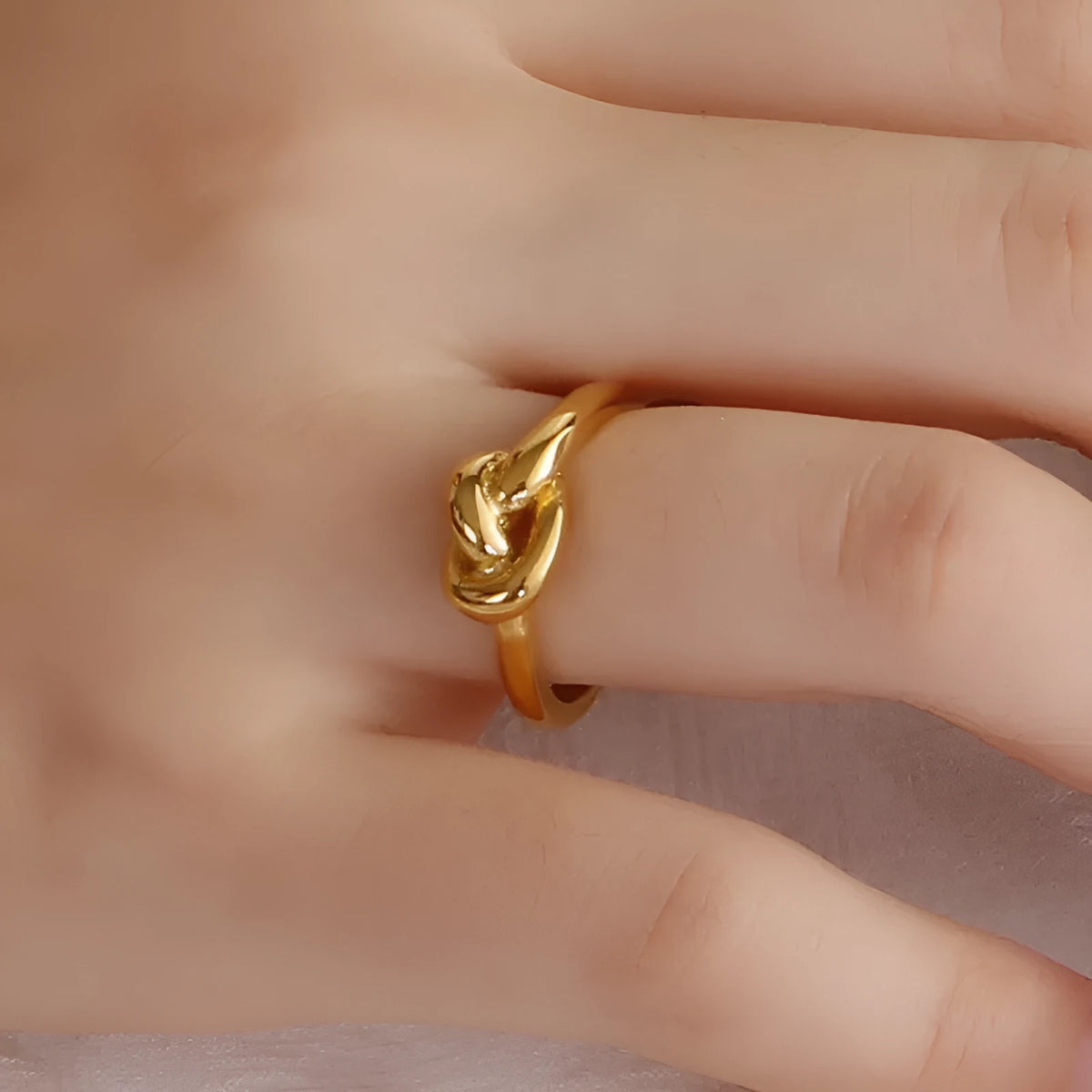 Truelove knot geometric titanium steel ring in gold KR82086-K on white background