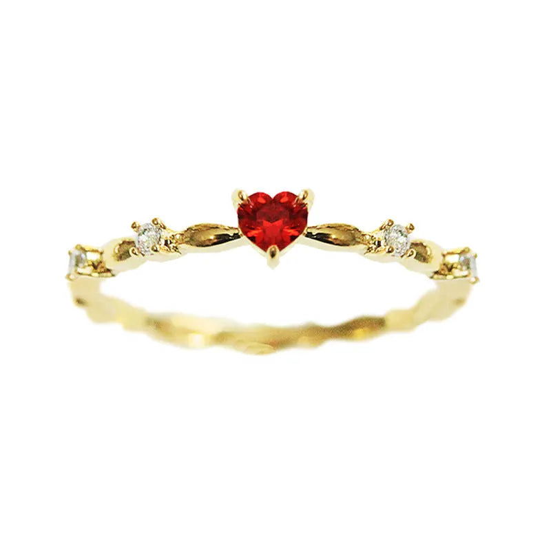 Gold or silver peach heart-shaped ring with clear zircon stones on a copper band.