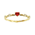 Gold or silver peach heart-shaped ring with clear zircon stones on a copper band.