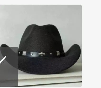 Brown leather velvet curved edge Western cowboy hat with a conical crown on a wooden surface.