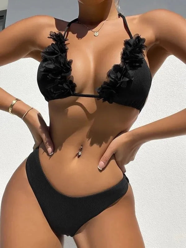 Black gathered style polyester swimwear set with a top and shorts on a mannequin