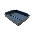 Black wireless charging storage box for QI standard phones on a desk