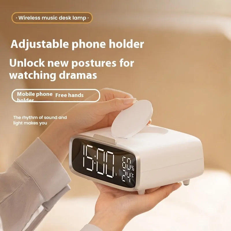 White wireless charging Bluetooth speaker alarm clock with LED night light on bedside table