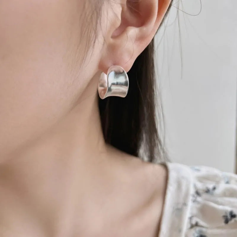 Pair of 925 silver women's ear studs with a wide irregular curved shape, 12 x 17.5mm, silver colour