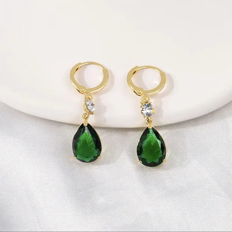 A pair of green geometric teardrop alloy earrings on a white background.