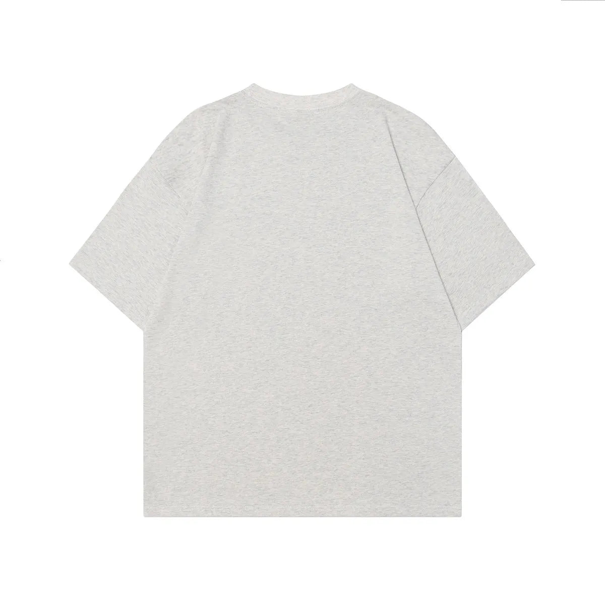Man wearing a grey loose-fit cotton T-shirt with a retro painting character design on the front.