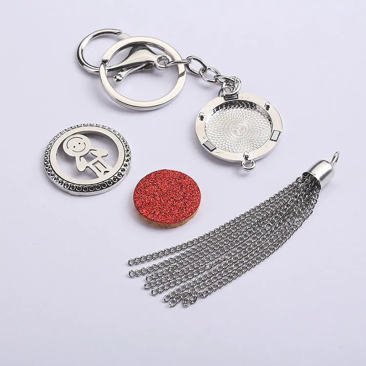 Tassel aromatherapy car pendant with alloy chain hanging from a rear-view mirror.