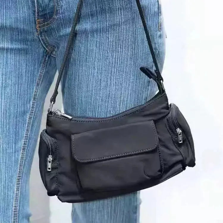 Black PU leather women's shoulder bag with side line detail and double interior pockets.