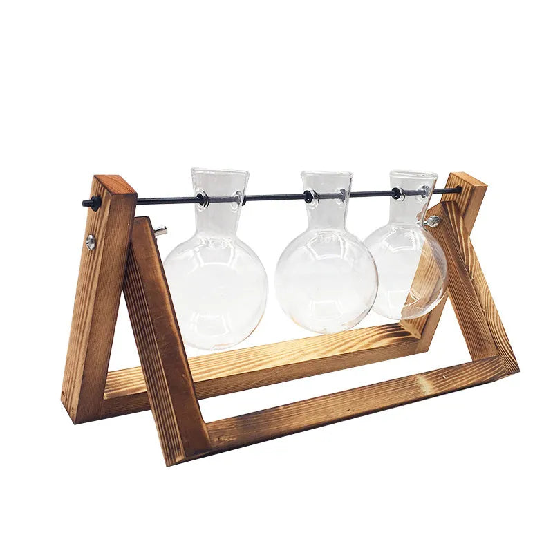 Hydroponic borosilicate glass vase in a wooden swing stand with iron frame, geometric pastoral design for indoor plant display