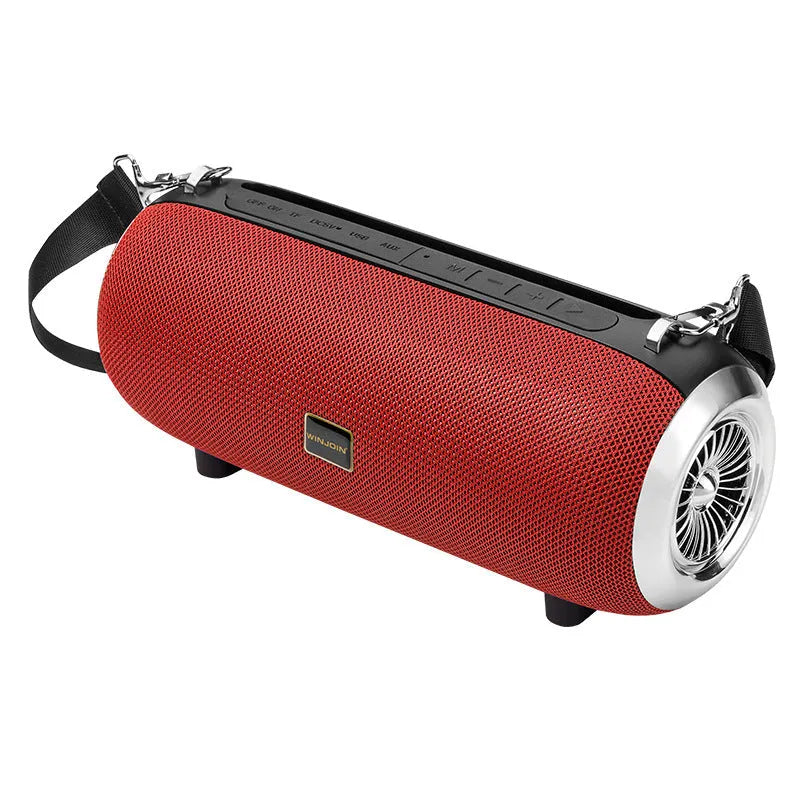 F666 portable fabric Bluetooth speaker with shoulder strap on a table next to a phone
