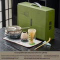 Seven-piece Japanese style matcha set with ceramic bowl, bamboo whisk, stand, tea tray, filter screen, and tea towel in gift box