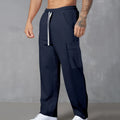 Men's navy blue corduroy cargo trousers with a drawstring waist and straight legs laid flat.