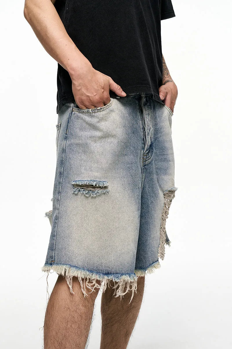 Light blue washed denim shorts with baggy wide leg cut and zipper fly