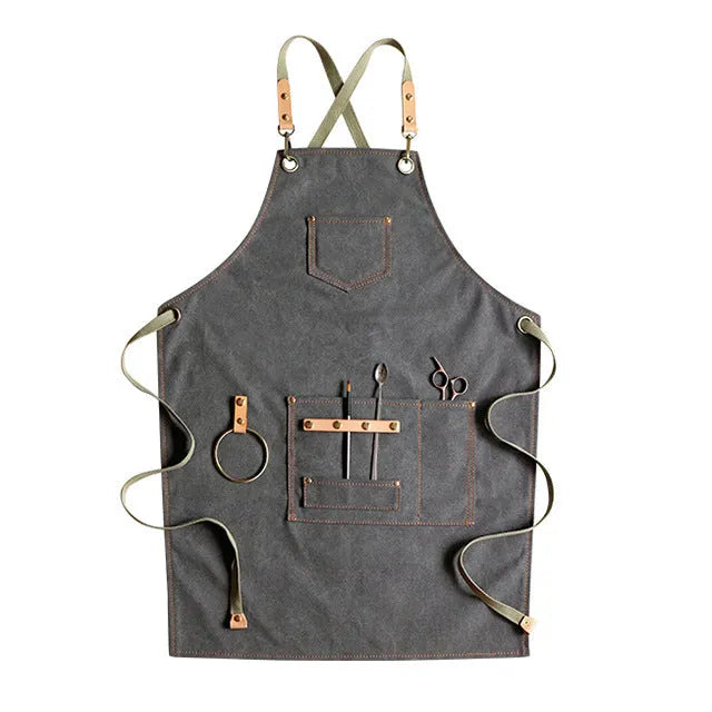 Canvas apron with cross-back straps in camel colour.