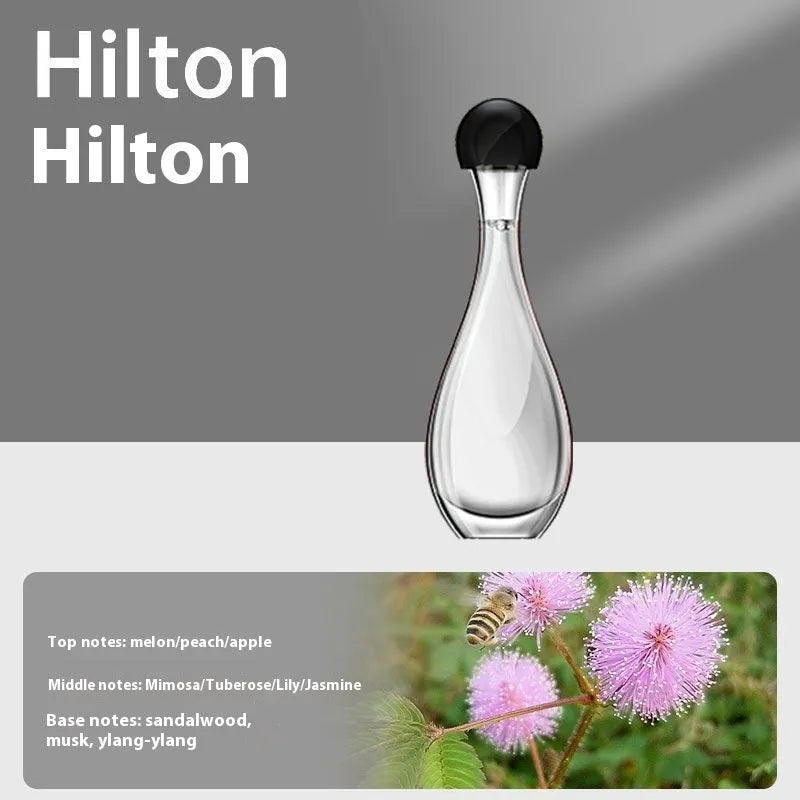 White ultrasonic aroma diffuser with control buttons and mist output, shown with essential oil bottle
