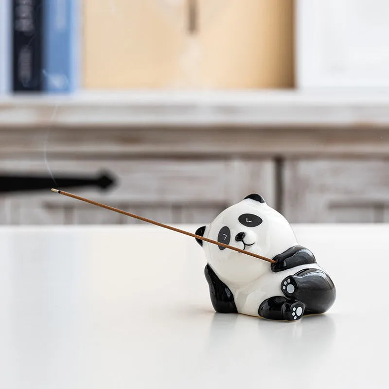 Ceramic panda incense holder with open eyes placed on a desk for aromatherapy use, 8.5cm long