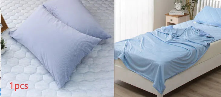 Blue and grey polyester cooling blanket with Japanese Q-Max fibres on a bed.