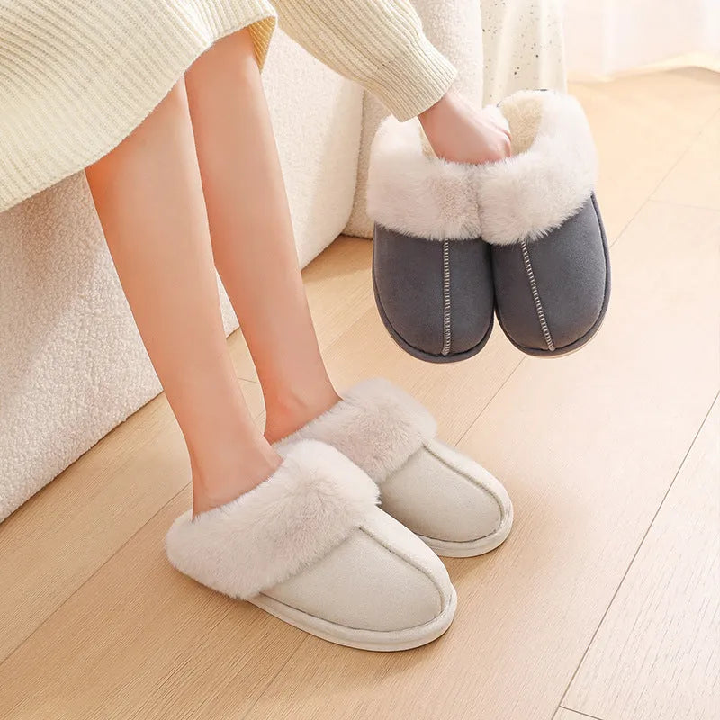 Women's plush winter slippers in grey with a round toe, flat heel, and non-slip PVC sole.