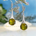 Olive green topaz coloured water drop shape earrings with minimalist retro styling on white background