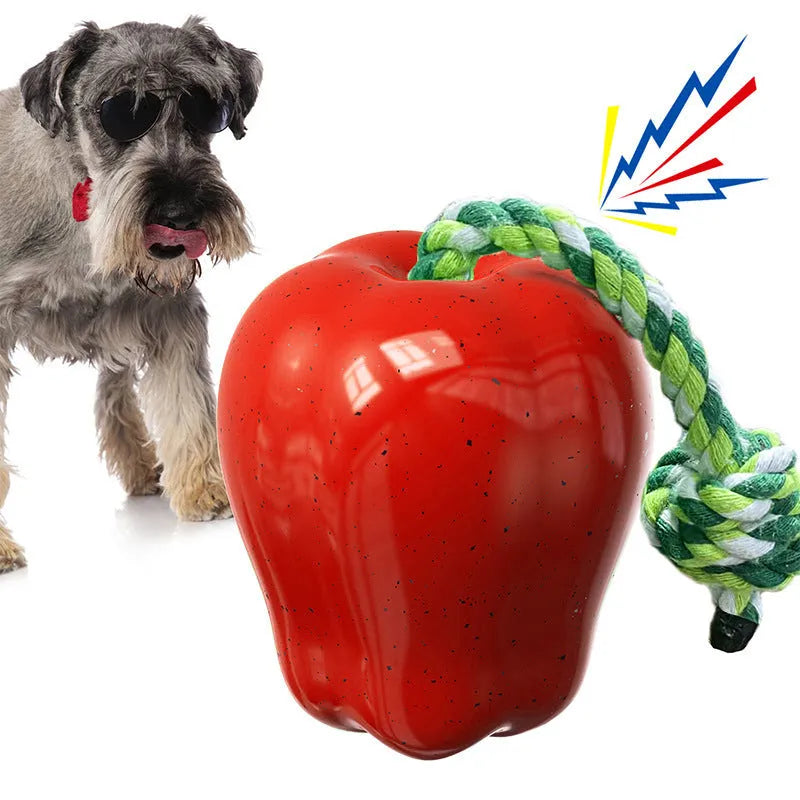 Green apple-shaped dog molar toy with dropping ball mechanism on white background