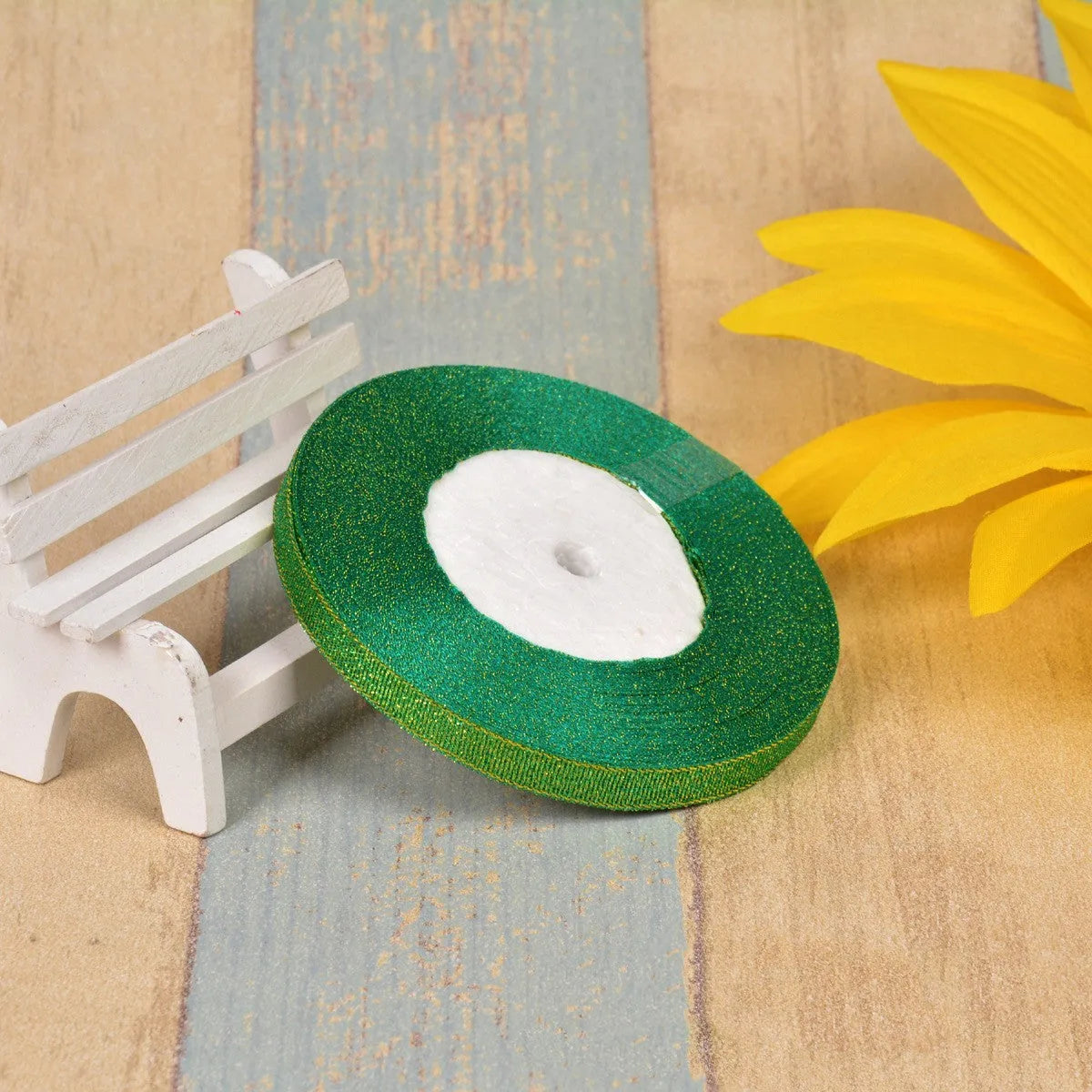 A roll of colourful green onion pattern polyester ribbon with metallic wire highlights, shown at 3-points width.