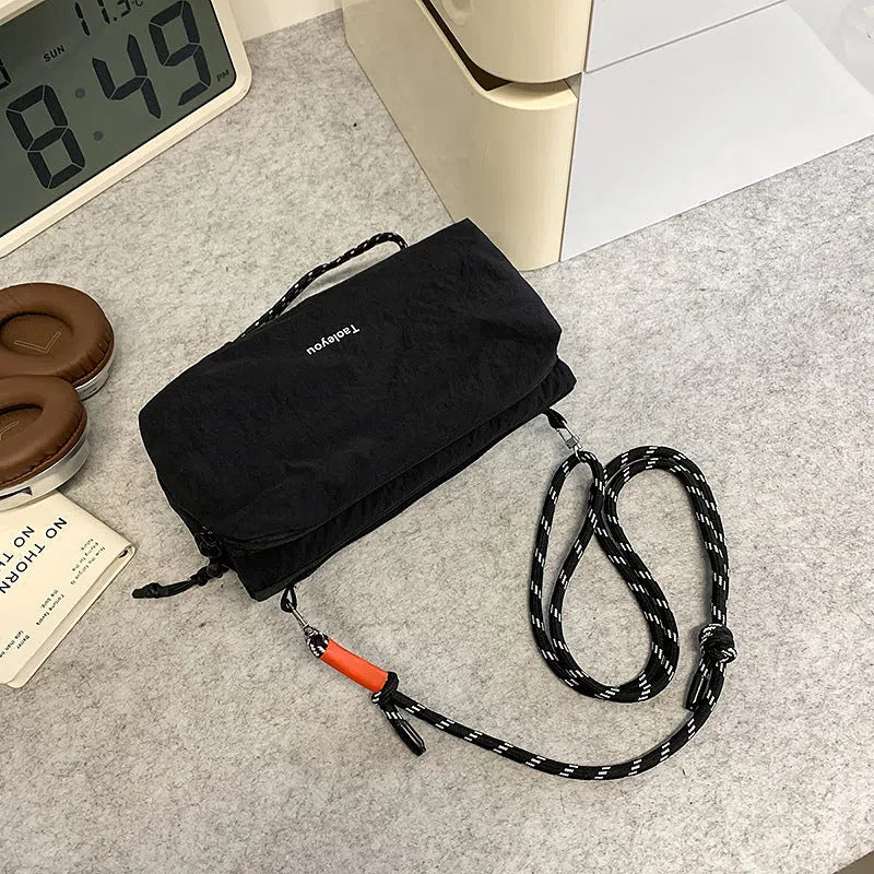 Women's sports crossbody bag nylon pillow shape 22cm length 4cm width 9cm height stitching black