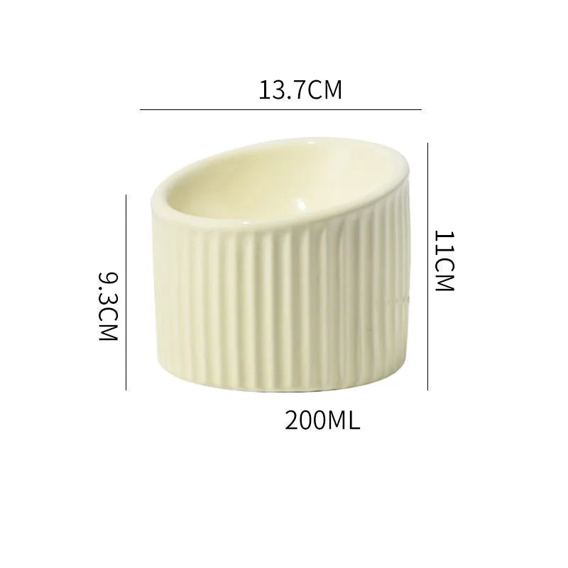 Ceramic elevated cat bowl in green with tilted round shape and raised feeding height