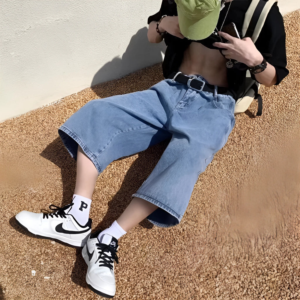 Blue men's cropped high-waisted denim-style shorts with a zipper fly on a white background.