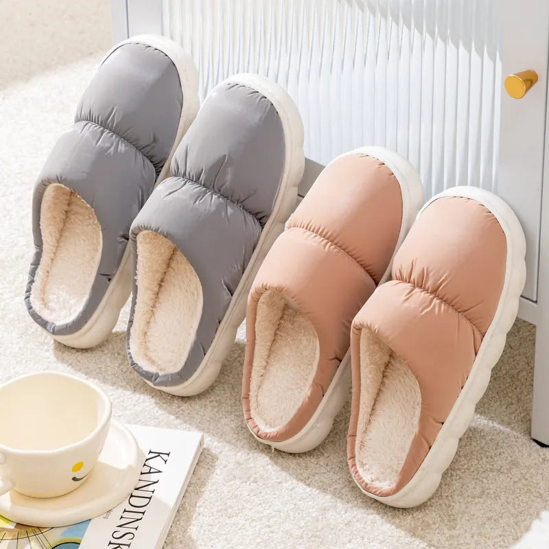 A pair of thick-soled indoor slippers with an artificial leather upper and soft plush lining, shown in a choice of colours.