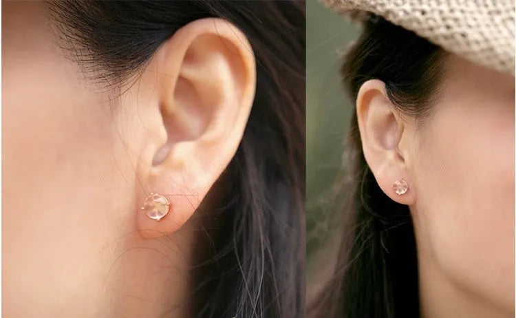 Rose gold plated drop shape stud earrings with a synthetic quartz crystal inlay detail.