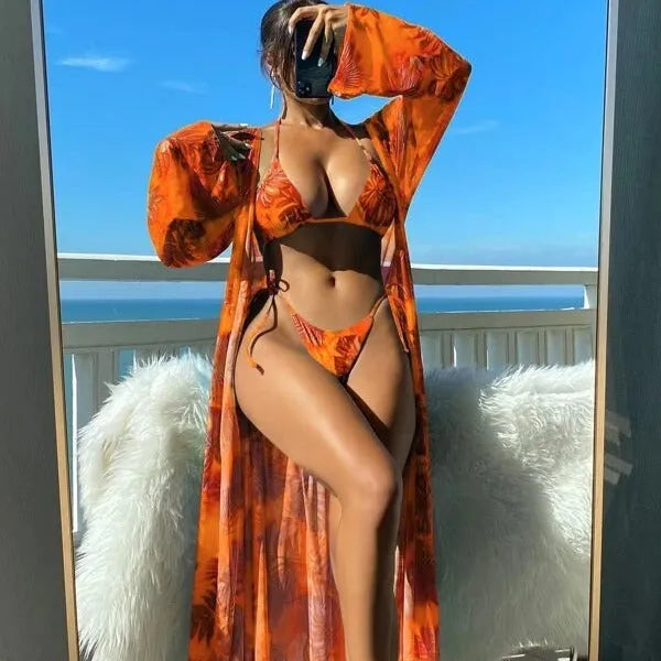 Split long sleeve banded bikini swimsuit set in a floral pattern with a matching outer robe.