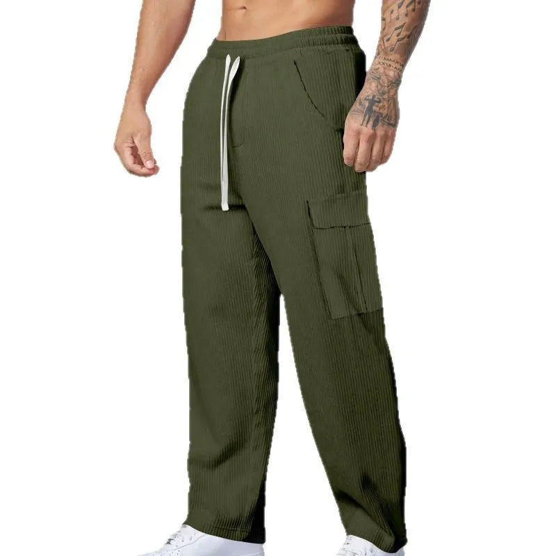 Men's navy blue corduroy cargo trousers with a drawstring waist and straight legs laid flat.