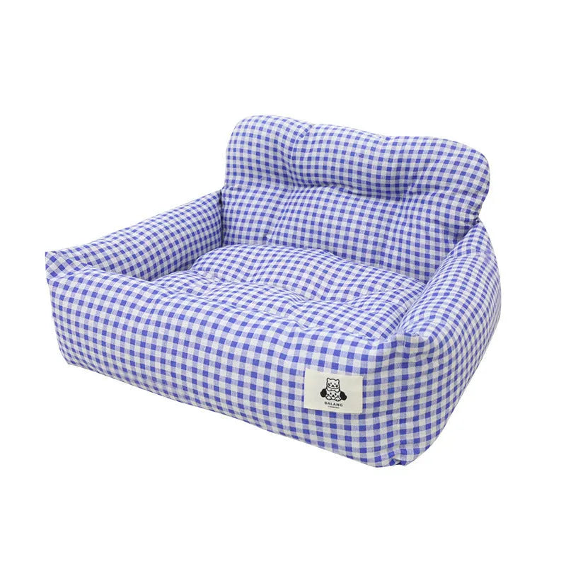 Grey and blue plaid portable dog car travel nest with stain-resistant cloth fabric.