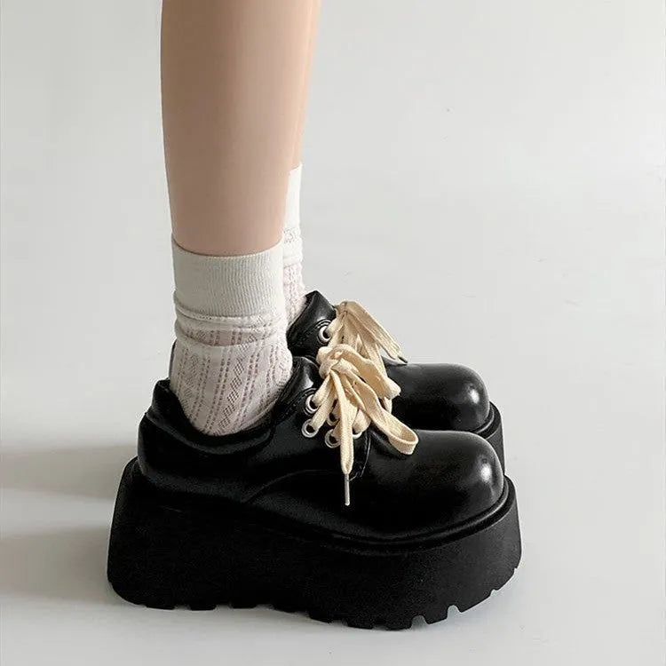 Matte black women's lace-up shoes with a chunky rubber sole and 6-8cm heel.